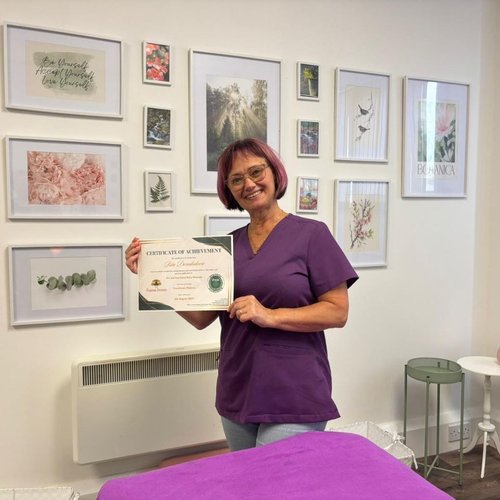 Rita holding a professional massage certificate