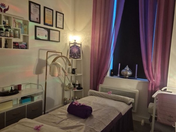 Professional treatment room with certificates and warm lighting