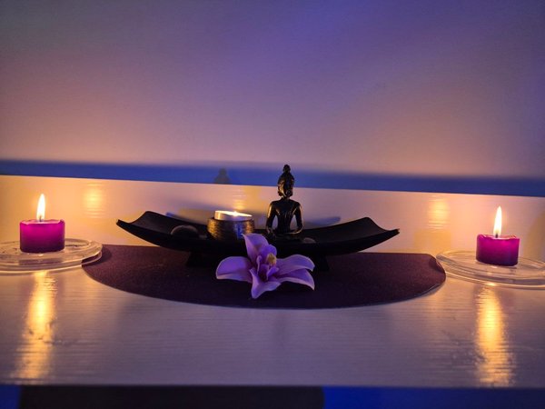 Zen decoration with Buddha statue, candles and orchid